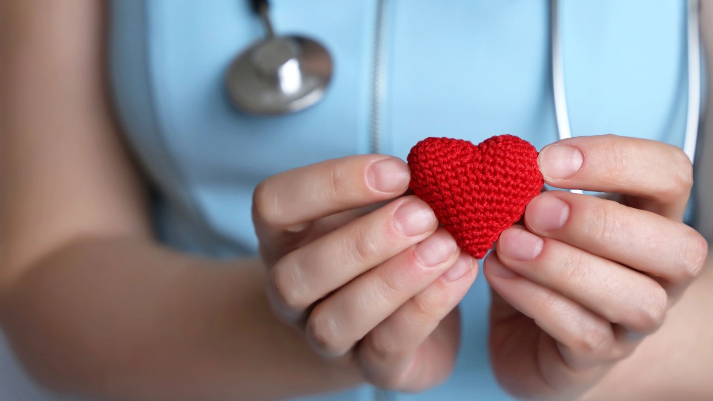 Doctor holding crochet heart in hands