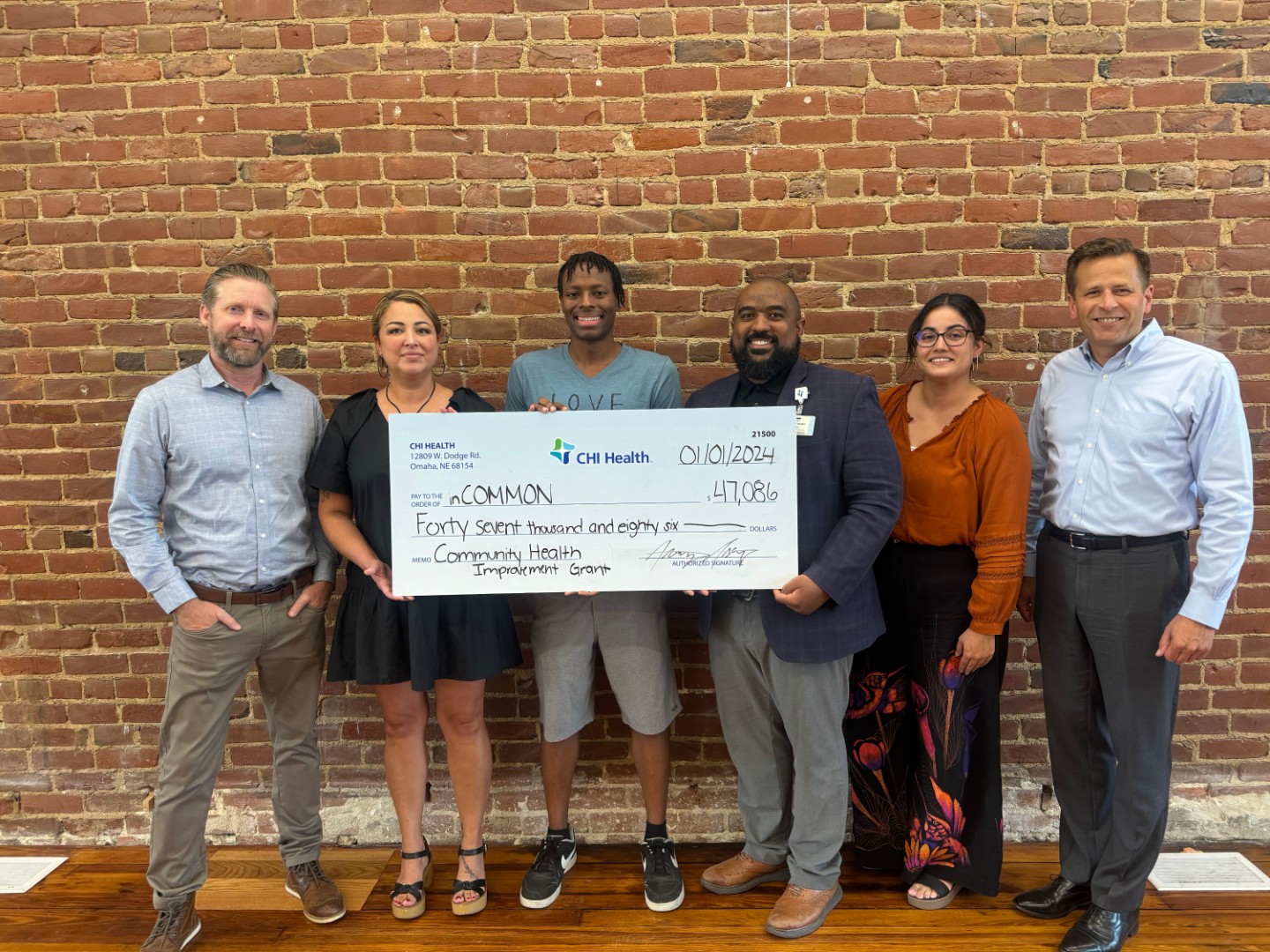 Group photo of check presentation to In Common