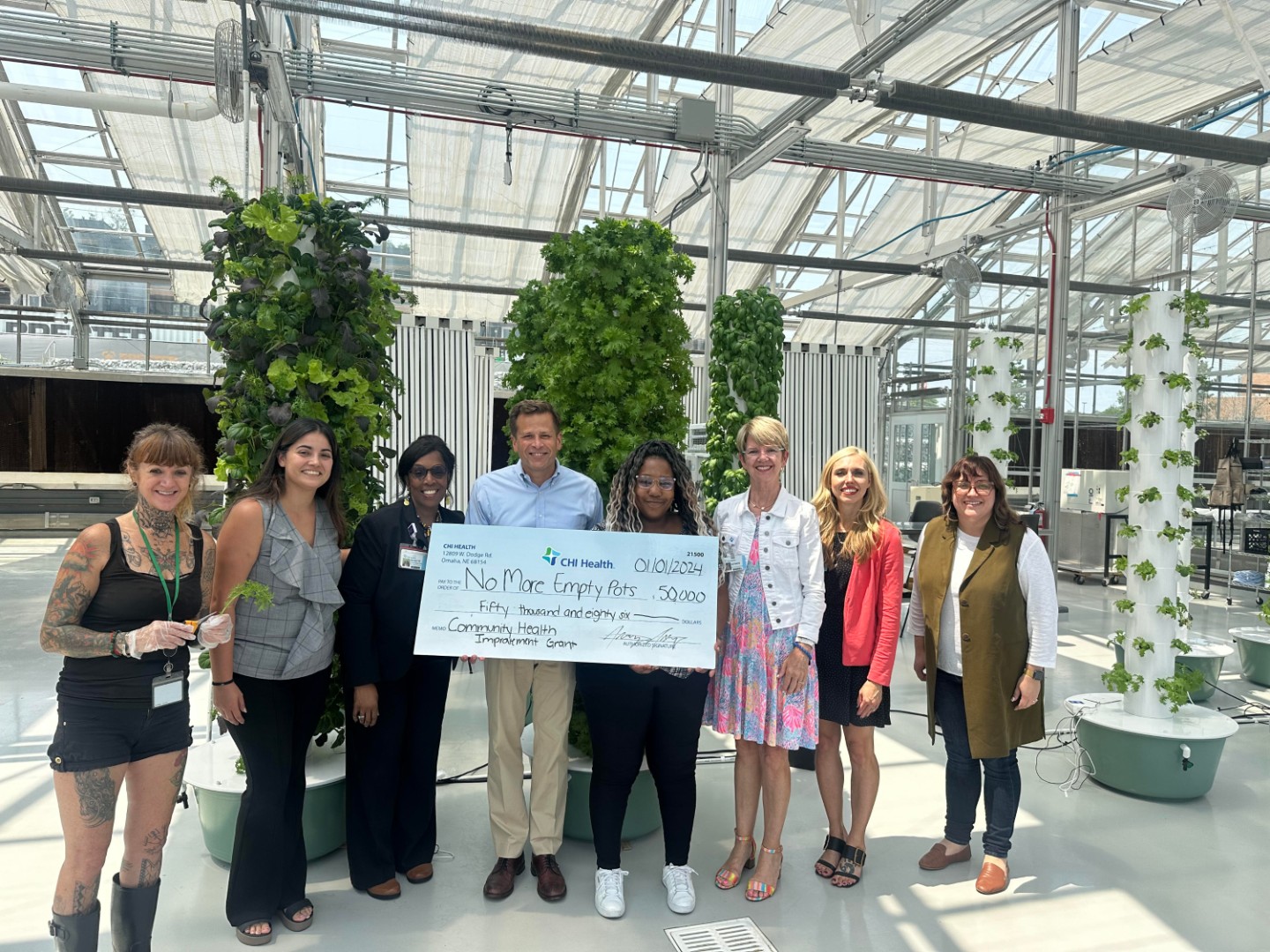 Group photo of check presentation to No More Empty Pots