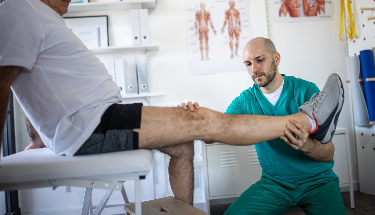 Provider checking a patient's knee and leg